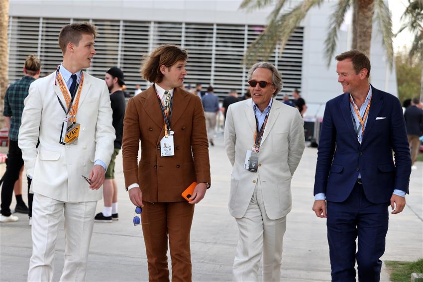 Englishmen walking to paddock club in suits